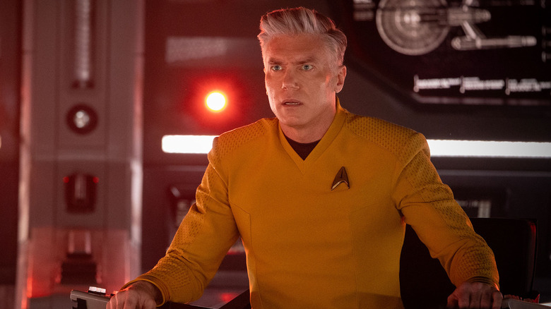 Captain Pike looking alarmed aboard the Enterprise's main deck in Star Trek: Strange New World