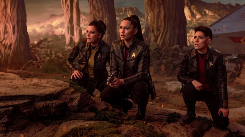 Una Chin-Riley, La'An Noonien-Singh, and Erica Ortegas crouching together on Star Trek: Strange New Worlds
