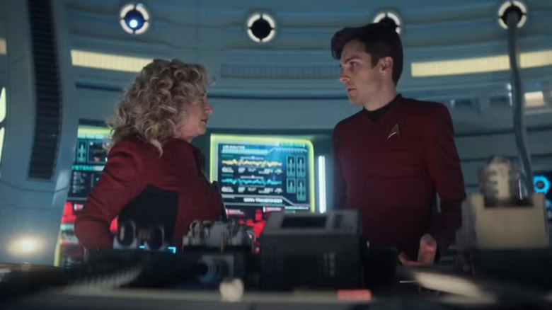 Pelia and Scotty standing over damaged machinery in Star Trek: Strange New Worlds