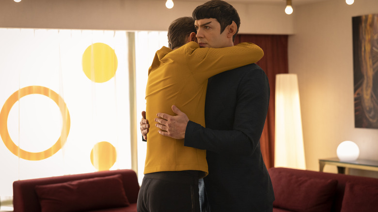 Paul Wesley as James T. Kirk embracing Ethan Peck as Spock in a brightly-lit room in Star Trek: Strange New Worlds