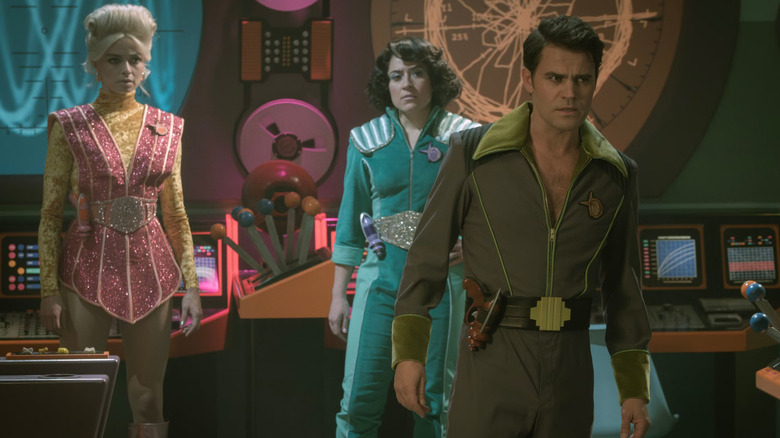 Star Trek Strange New Worlds - The Space Adventure Hour - Chapel, Ortegas, and Kirk dressed in cheesy sci-fi outfits