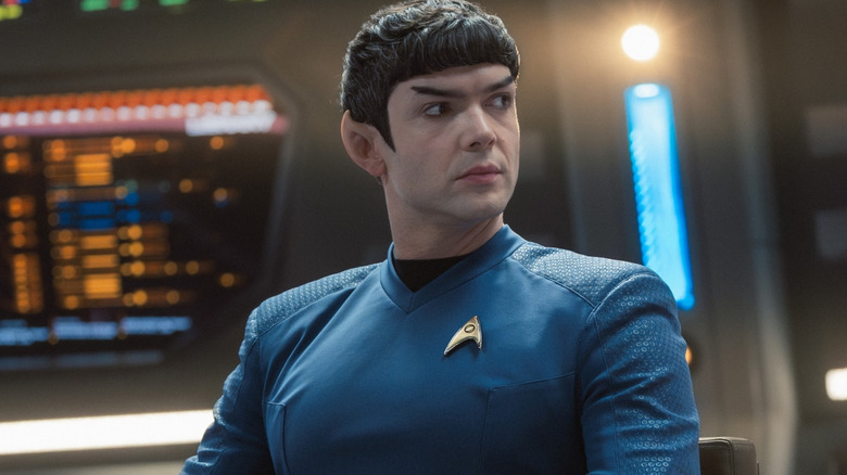 Ethan Peck as Spock sitting in the command chair of a starship in Star Trek: Strange New Worlds
