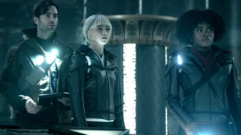 Roger Korby, Nurse Chapel, and Ensign Uhura in a darkened temple on Star Trek: Strange New Worlds