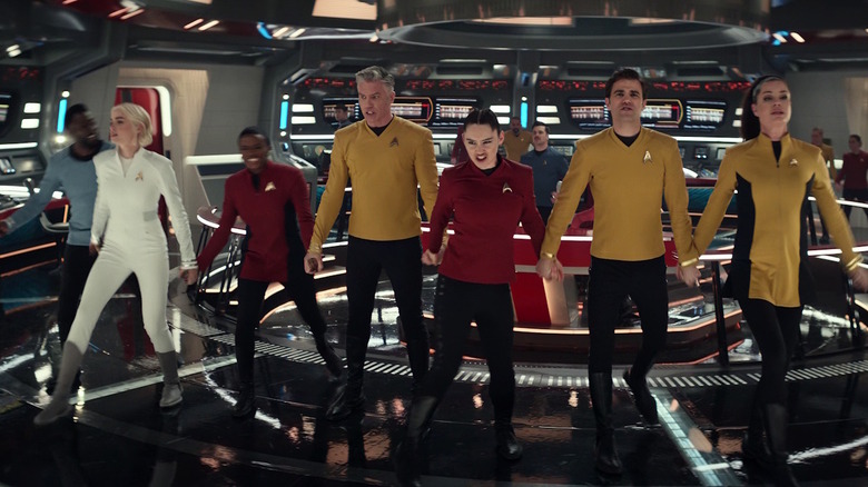 The crew of the Enterprise holding hands in Star Trek: Strange New Worlds