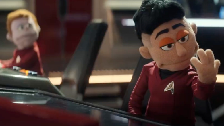 Star Trek: Strange New Worlds - Ortegas, turned into puppet, sitting at Enterprise helm and looking at her hand