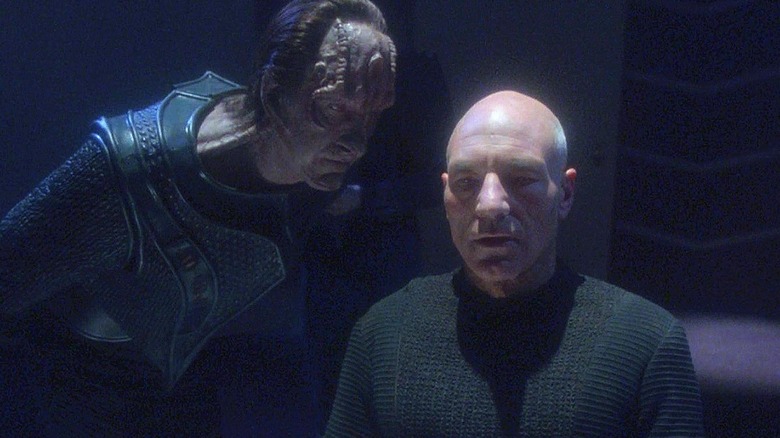 Gul Madred (David Warner) glares leaning over Jean-Luc Picard (Patrick Stewart) in Star Trek: The Next Generation