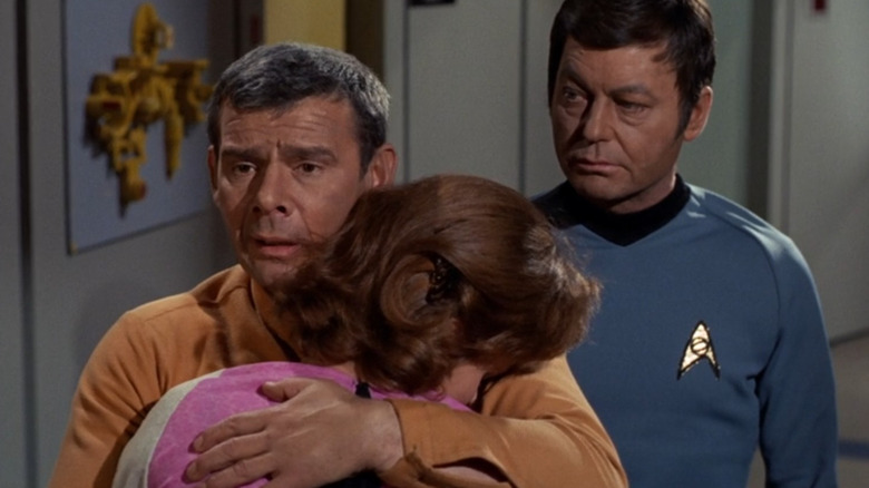 Man holds Dr. Lester, on Star Trek.