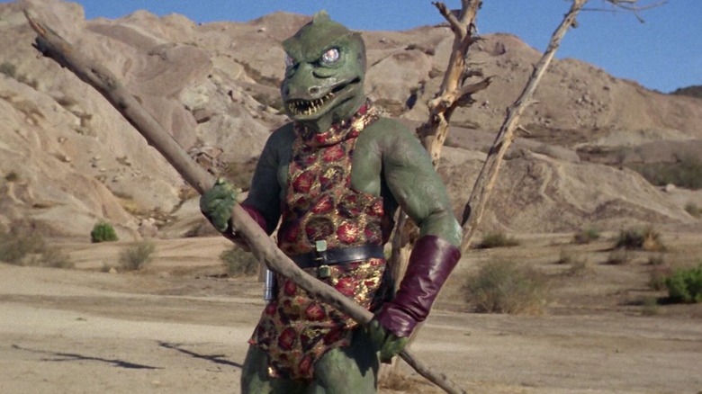 A Gorn holding a branch on Star Trek