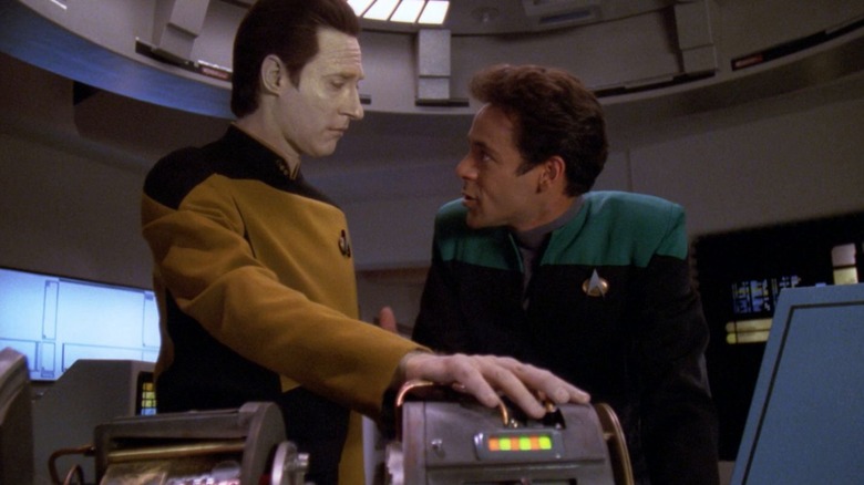 Data touching a machine and talking to Dr. Bashir on Star Trek: The Next Generation