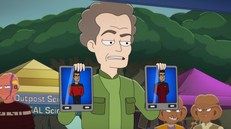 A man holding up two pictures of men in uniforms on Star Trek: Lower Decks