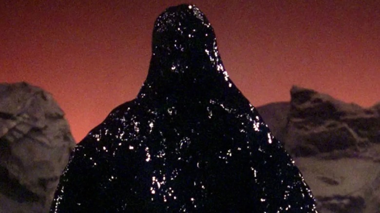 The goopy oil slick, Armus, against his red world, on The Next Generation