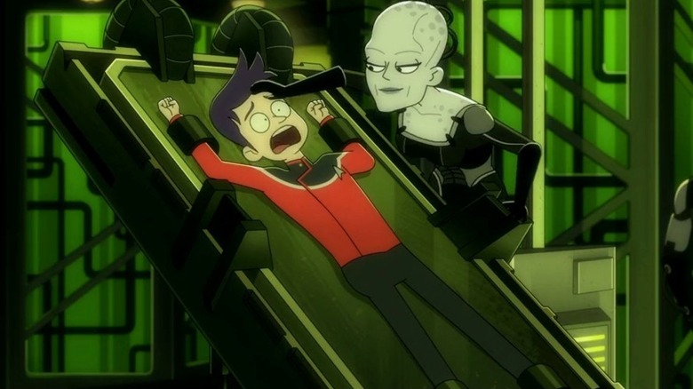 Ensign Brad Boimler is trapped on a board while the Borg Queen looks at him in Star Trek: Lower Decks