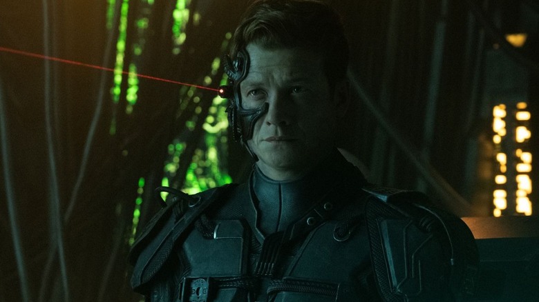Ed Speleers as Jack Crusher in his Borg form stands and looks toward the left in Star Trek: Picard
