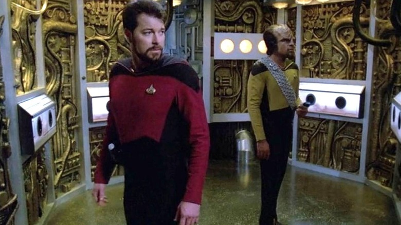 Jonathan Frakes as Commander Will Riker and Michael Dorn as Lieutenant Worf stand in a Borg nursery in Star Trek: The Next Generation