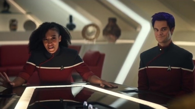 Beckett Mariner (Tawny Newsome) and Brad Boimler (Jack Quaid) sit smiling at a table in Star Trek: Strange New Worlds