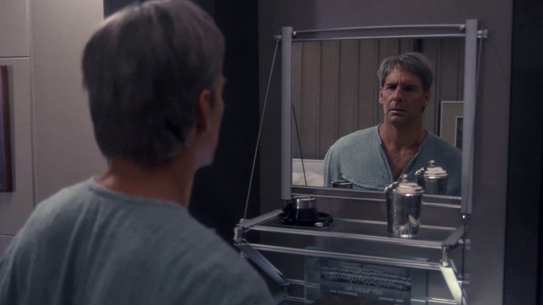 An older Jonathan Archer (Scott Bakula) stares at himself in a mirror in Star Trek: Enterprise