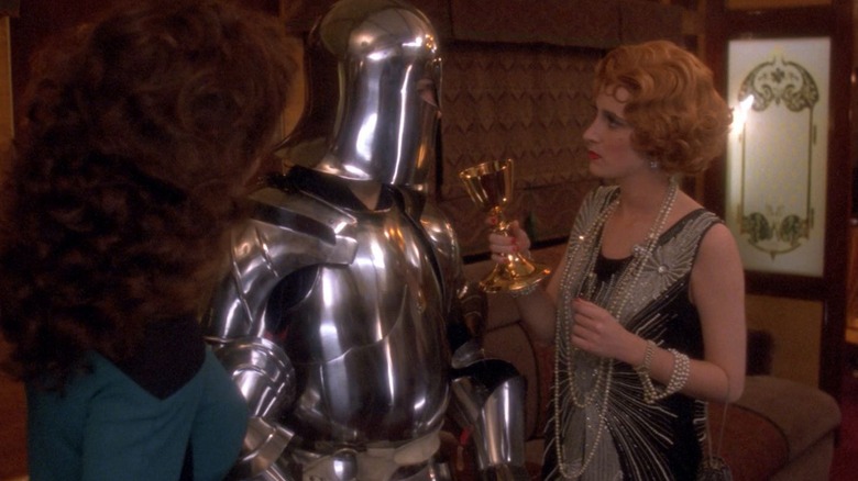 Troi looking at a knight and a flapper on Star Trek: The Next Generations