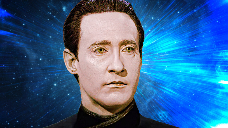 Brent Spiner as Data standing in front of a blue background of space in Star Trek: The Next Generation