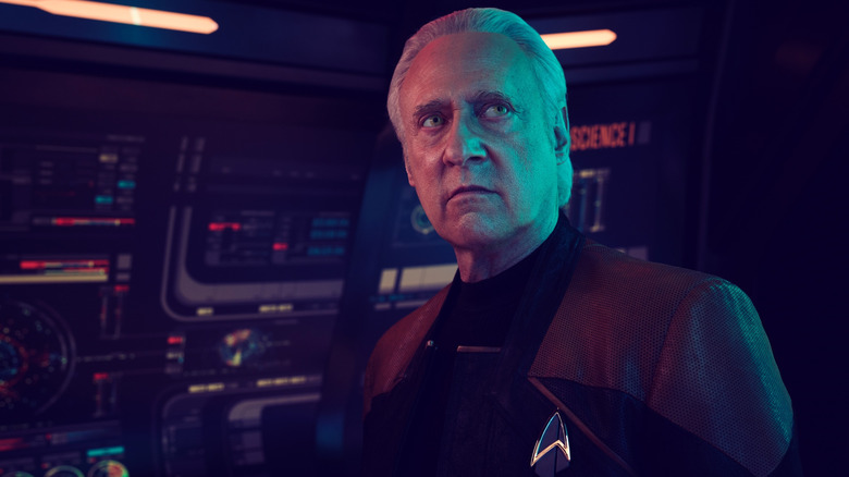 Brent Spiner as Data standing on the bridge of a starship in front of several control panels in Star Trek: Picard