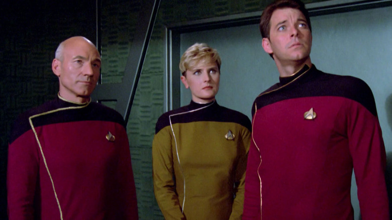 Patrick Stewart as Jean-Luc Picard standing next to Denise Crosby as Tasha Yar and Jonathan Frakes as William Riker in Star Trek: The Next Generation