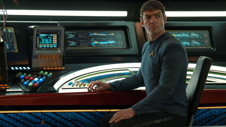 Ethan Peck as Spock sitting at his console on the bridge of a starship in Star Trek: Strange New Worlds