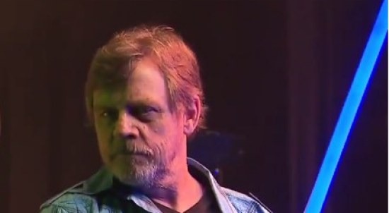 bearded mark hamill with lightsaber from disneyworld video