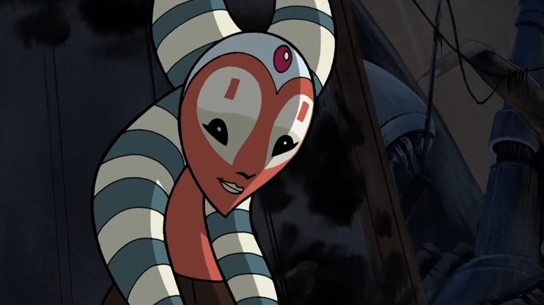 Shaak Ti smiles while standing in some wreckage in Star Wars: Clone Wars