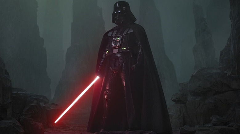 Darth Vader with his lightsaber extended standing amongst the rocks in Obi-Wan Kenobi
