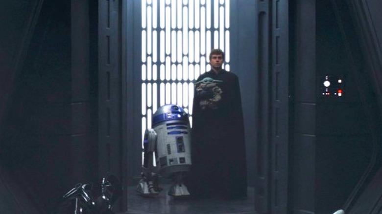 Luke Skywalker carrying Grogu
