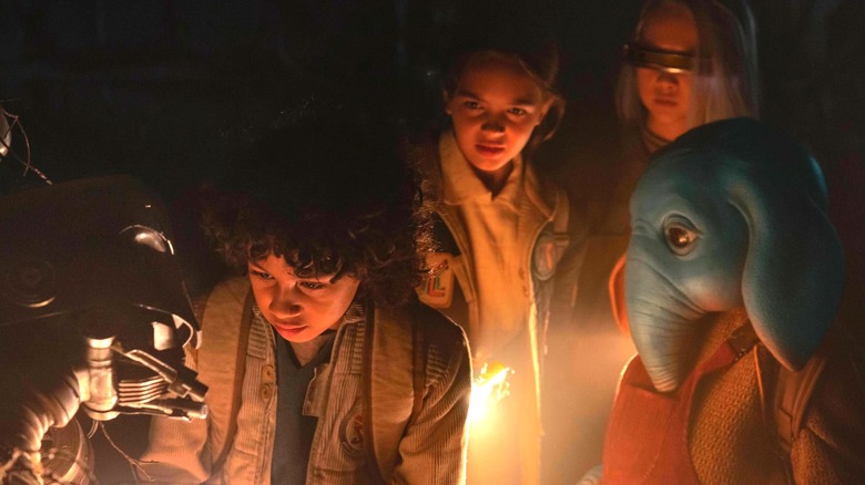 Fern, KB, Wim, and Neel examine a robot in Star Wars: Skeleton Crew