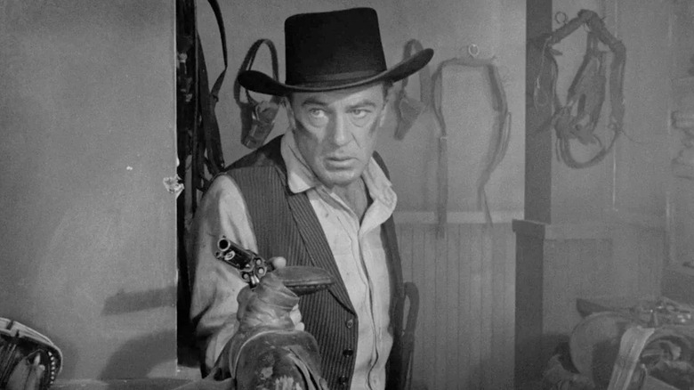 Gary Cooper as Marshal Will Kane, wielding a revolver, in High Noon