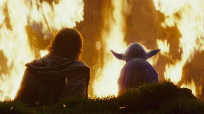 Luke and Yoda watch a fire  in Star Wars: The Last Jedi