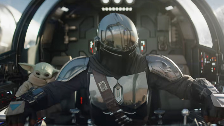 Din Djarin and Grogu sitting in their spaceship about to take off in The Mandalorian and Grogu