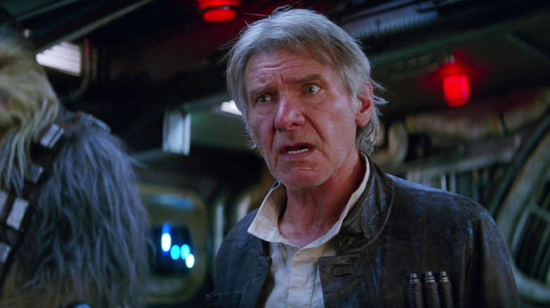 Han Solo looking baffled inside the Millennium Falcon in Star Wars: The Force Awakens