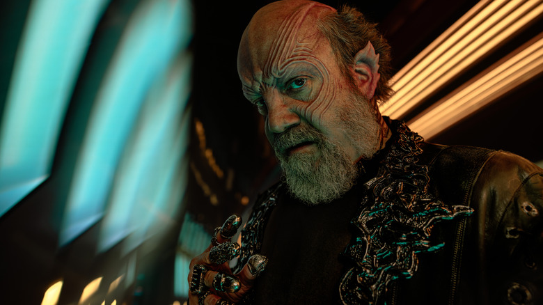 Paul Giamatti as Nus Braka staring at the camera in a threatening pose in Starfleet Academy