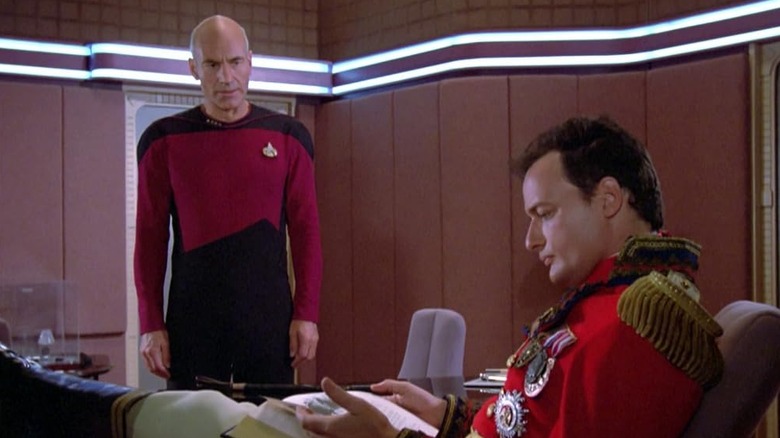 Patrick Stewart as Captain Picard looking at John de Lancie as Q in Star Trek: The Next Generation