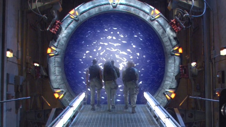 The SG-1 crew walks inside one of the iconic devices on Stargate SG-1