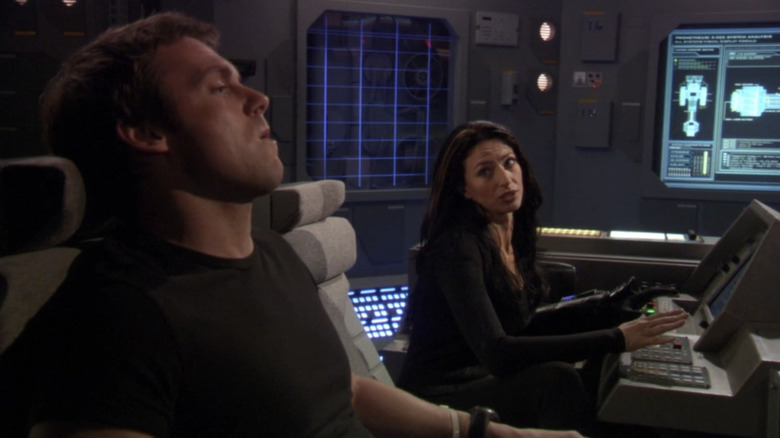Vala Mal Doran by Claudia Black looks at Daniel Jackson by Michael Shanks when he was sitting in a Stargate SG-1 control center