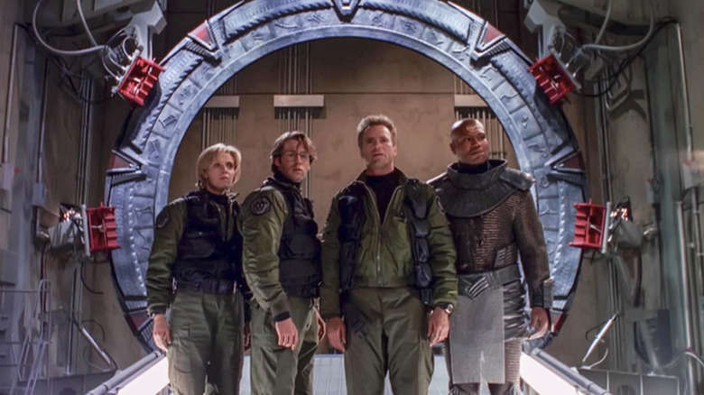 Teal'c, Samantha, Jack, and Daniel standing in front of the Stargate in Stargate SG-1 season 1