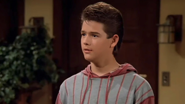 Brandon Call as J.T. standing in the living room in Step by Step