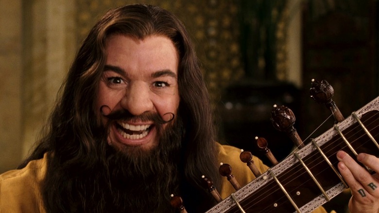 Guru Pitka, looking at the camera, playing a sitar in The Love Guru