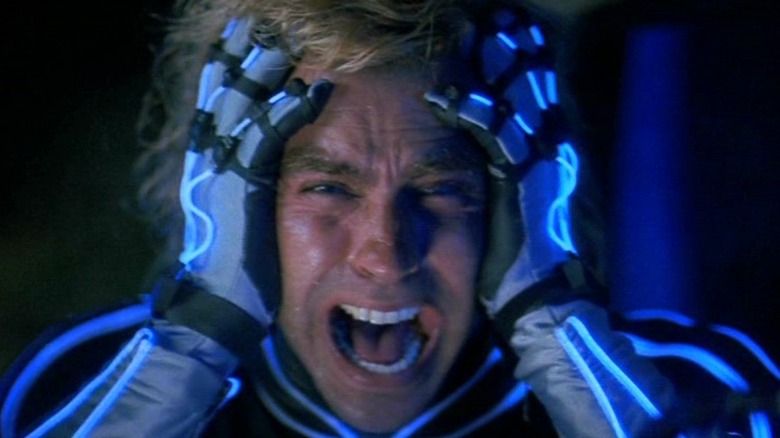 Jeff Fahey as Jobe Smith screaming and holding his head in The Lawnmower Man
