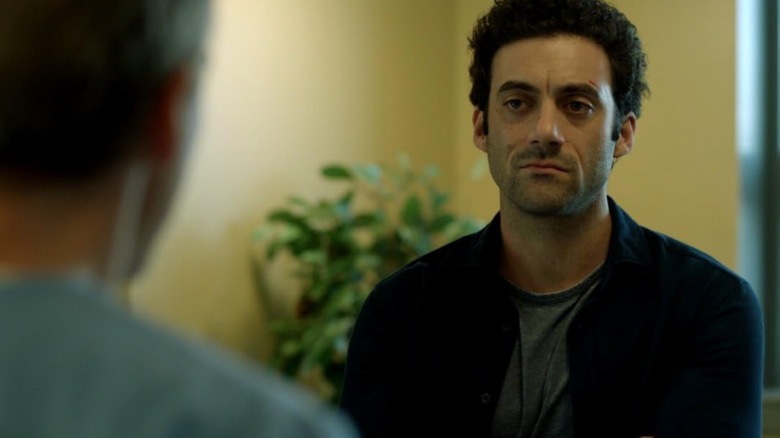Morgan Spector's Kevin Copeland looks unimpressed with the man he's speaking to in The Mist