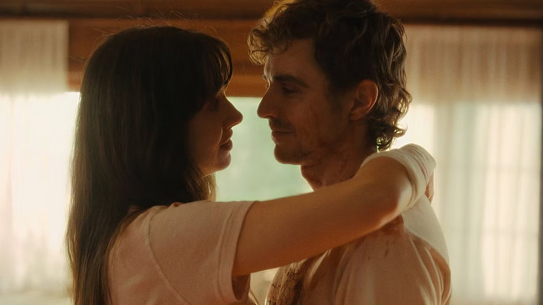 Millie and Tim looking lovingly at each other with some blood on them in Together