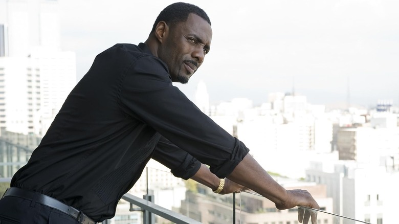 Gordon leaning against some railing in Takers