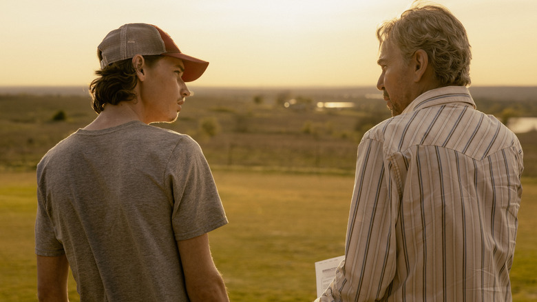 Jacob Lofland's Cooper Norris and Billy Bob Thornton's Tommy Norris are seen from behind as they stand side by side outside in Landman