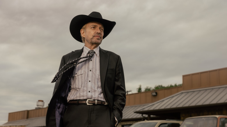 Billy Bob Thornton's Tommy Norris looks off into the distance as he stands outside in Landman
