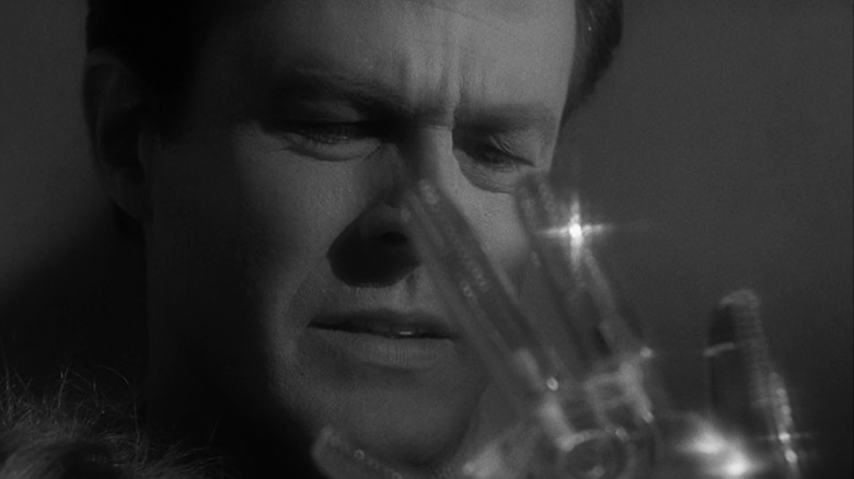 Robert Culp's Trent looks at his glass hand in closeup in The Outer Limits