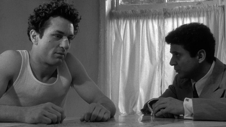Jake and Joey LaMotta sitting at a table in Raging Bull