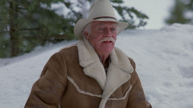 Richard Farnsworth as Sheriff Buster standing in the snow in Misery